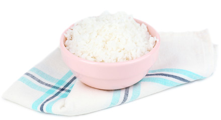 Cooked rice in bowl on napkin isolated on white