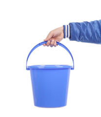 Hand holding blue bucket.