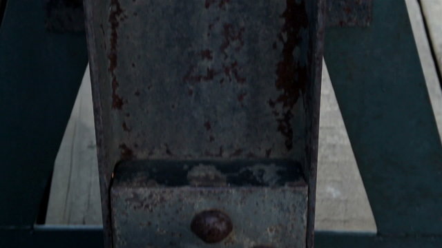 Close image of the steel bolt in the beam rusty big metal stand