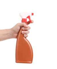 Hand holding brown plastic spray bottle.