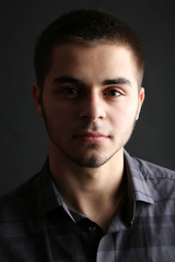Fototapeta premium Handsome young man on dark background