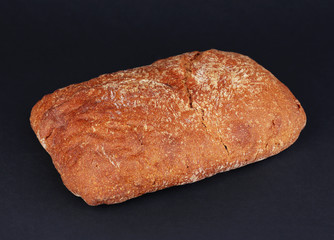 Loaf of bread on black background