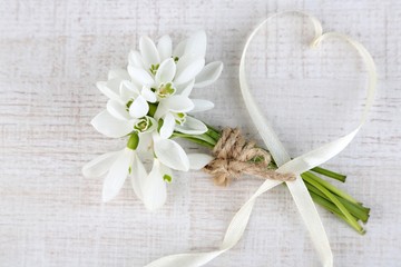 Bouquet of beautiful snowdrops on wooden background