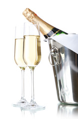 Glasses of champagne and bottle in pail, isolated on white