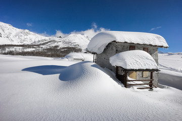 winter landscape, hut covered with snow in the mountains