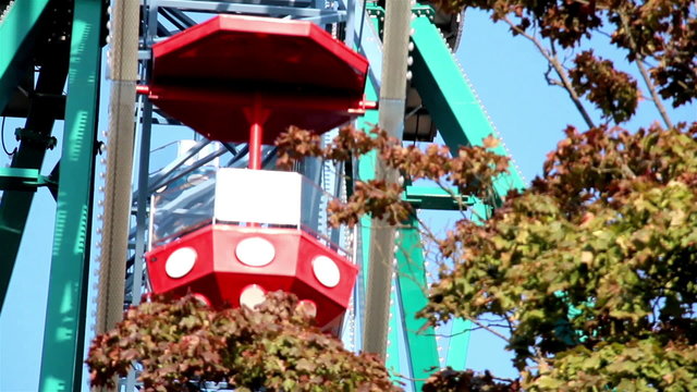 Martian themed ferris wheel moving blue sky