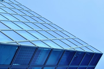Fototapeta na wymiar Abstract view of modern blue glass business center