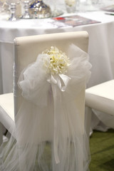 Detail of a chair decorated for a wedding reception