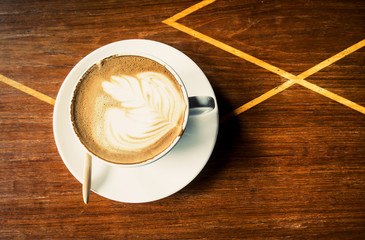 Cup of latte coffee on wood