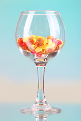 Goblet with pills on natural background