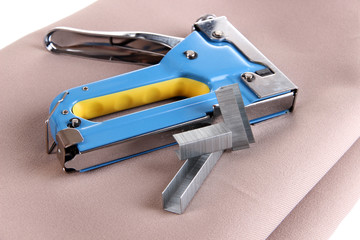 Construction stapler on fabric close up