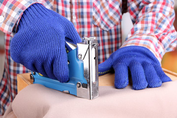 Fastening fabric and wooden box using construction stapler