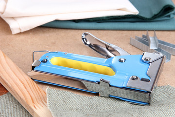 Construction stapler with fabric and staples