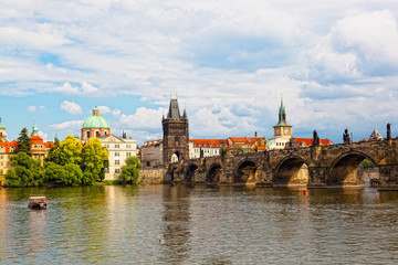 Naklejka premium Prague, view of Karlov Bridge and tourists going on it