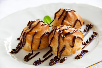 profiteroles with cream and chocolate sauce.