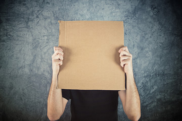Man holding blank cardboard paper