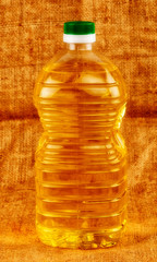 Olive oil bottle on burlap background