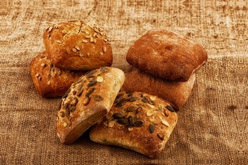 Various types of bread background burlap sack
