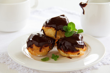 profiteroles with cream and chocolate sauce.