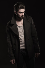 Obraz premium side view of a casual man in overcoat looking away