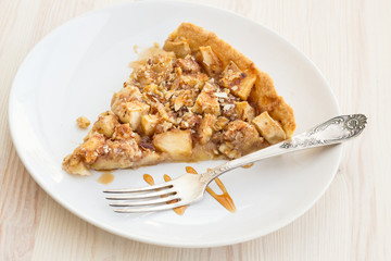 Slice of delicious fresh baked  apple pie on a wooden surface