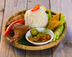 indonesian fried chicken rice on traditional background