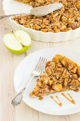 Slice of delicious fresh baked  apple pie on a wooden surface