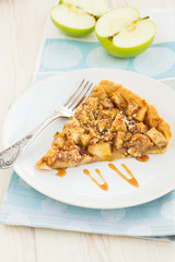 Slice of delicious fresh baked  apple pie on a wooden surface