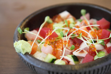 Sushi don , raw salmon tuna octopus on rice