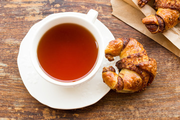 Cup of tea with croissant