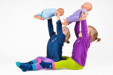 Twin Babies playing with dols