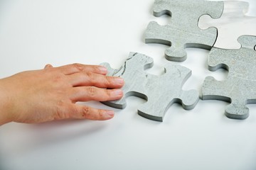 Kids connecting the jigsaw puzzle