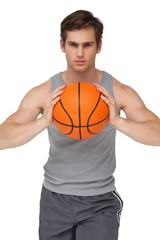 Fit man holding basketball about to throw to camera