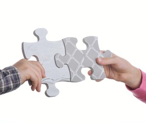 Kids connecting the jigsaw puzzle