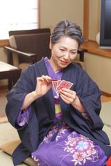 senior woman playing cards