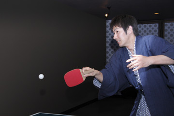 man in yukata playing table tennis