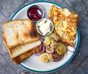 Yummy breakfast with omelette and potatoes