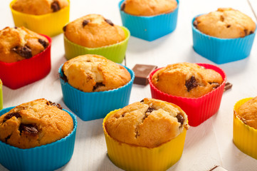 Prepare muffins. Muffins in colorful silicone molds on white boa