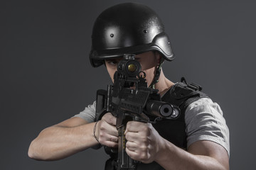 Security, paintball sport player wearing protective helmet aimin