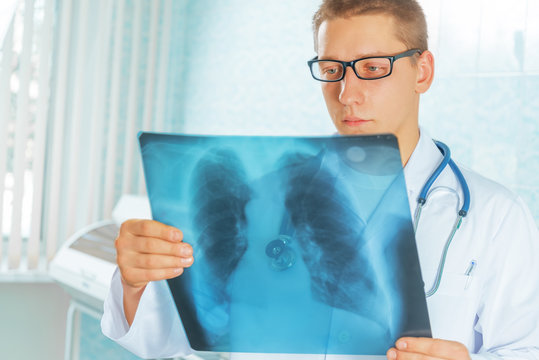 Physician looks at x-ray picture