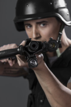 Gunfire, paintball sport player wearing protective helmet aiming