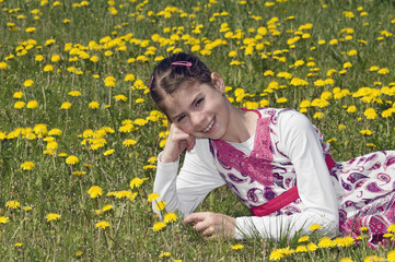 Girl in the flowering meadow smiling
