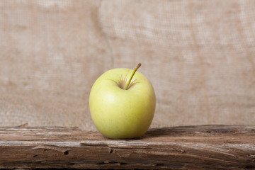Apple on wooden board