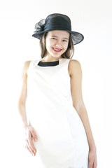 happy girl in white dress and black hat