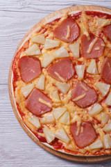 half Hawaiian pizza with pineapple and ham