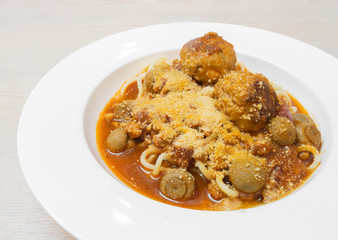 spaghetti and meatball on the white plate.