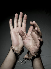 hands with handcuffs. Prison riot concept.