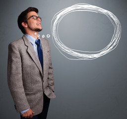 Good-looking man thinking about speech or thought bubble with co