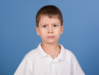 serious boy portrait on blue