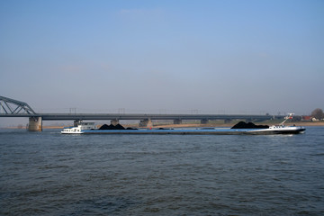 Obraz premium Inland cargo ship on the river